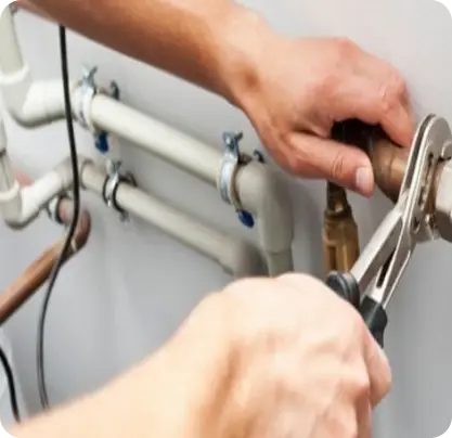 Berks Plumber tightening water supply pipe connection during residential plumbing repair