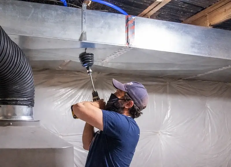 HVAC technician cleaning air ducts